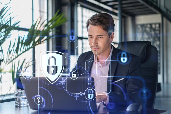 handsome-businessman-suit-workplace-working-with-laptop-defend-customer-cyber-security-concept-clients-information-protection-brainstorm-padlock-hologram-office-background.webp